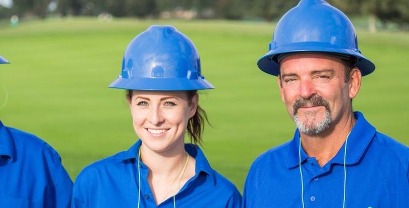 female and male golf course maintenance crew members
